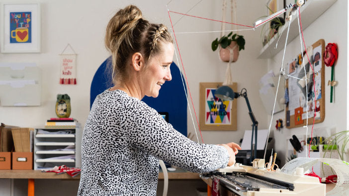 Me, Rosie, hard at work using my knitting machine at home.